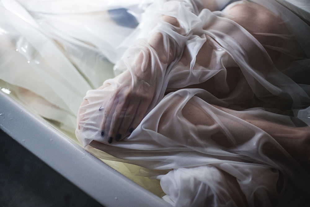 Hand covered in wet fabric