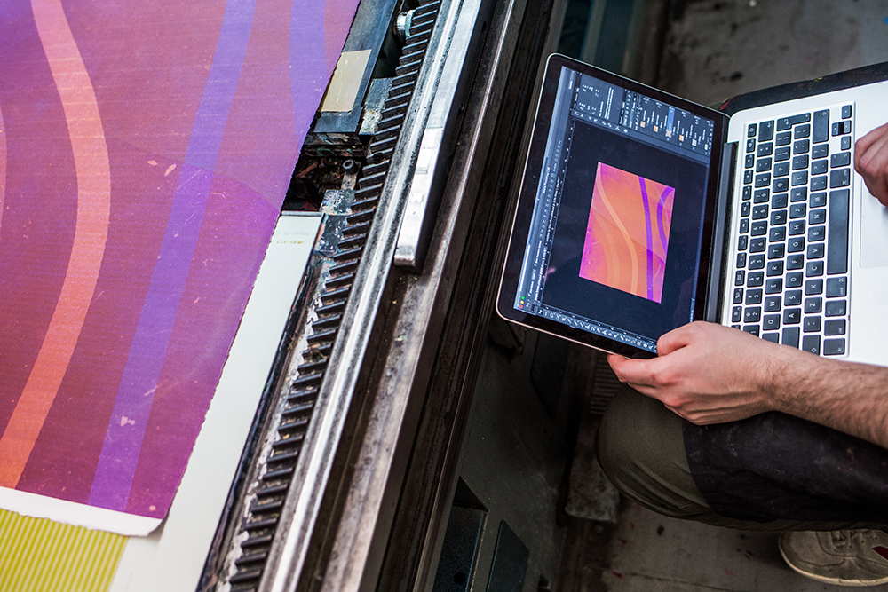 Vincent Hulme comparing his computer sketch and his print